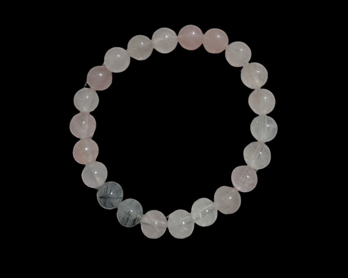 Overhead view of rose quartz and tourmalated quartz bracelet