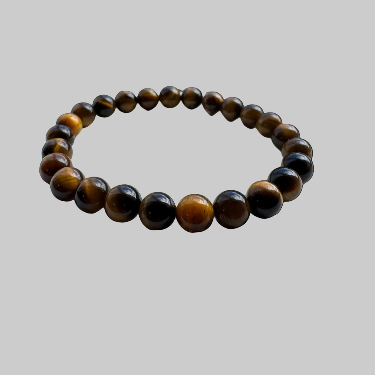 Angled view of golden-brown tiger eye bracelet