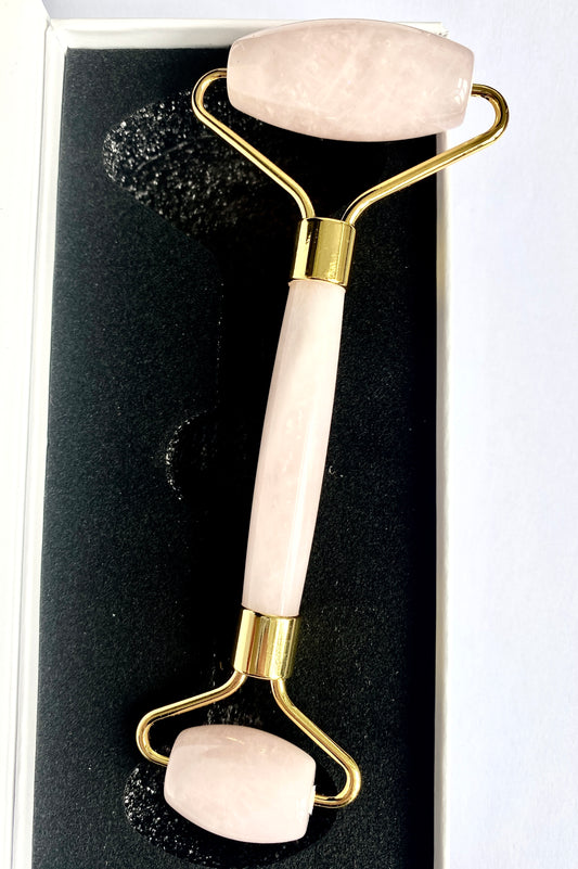 Dual-ended rose quartz facial roller in presentation box